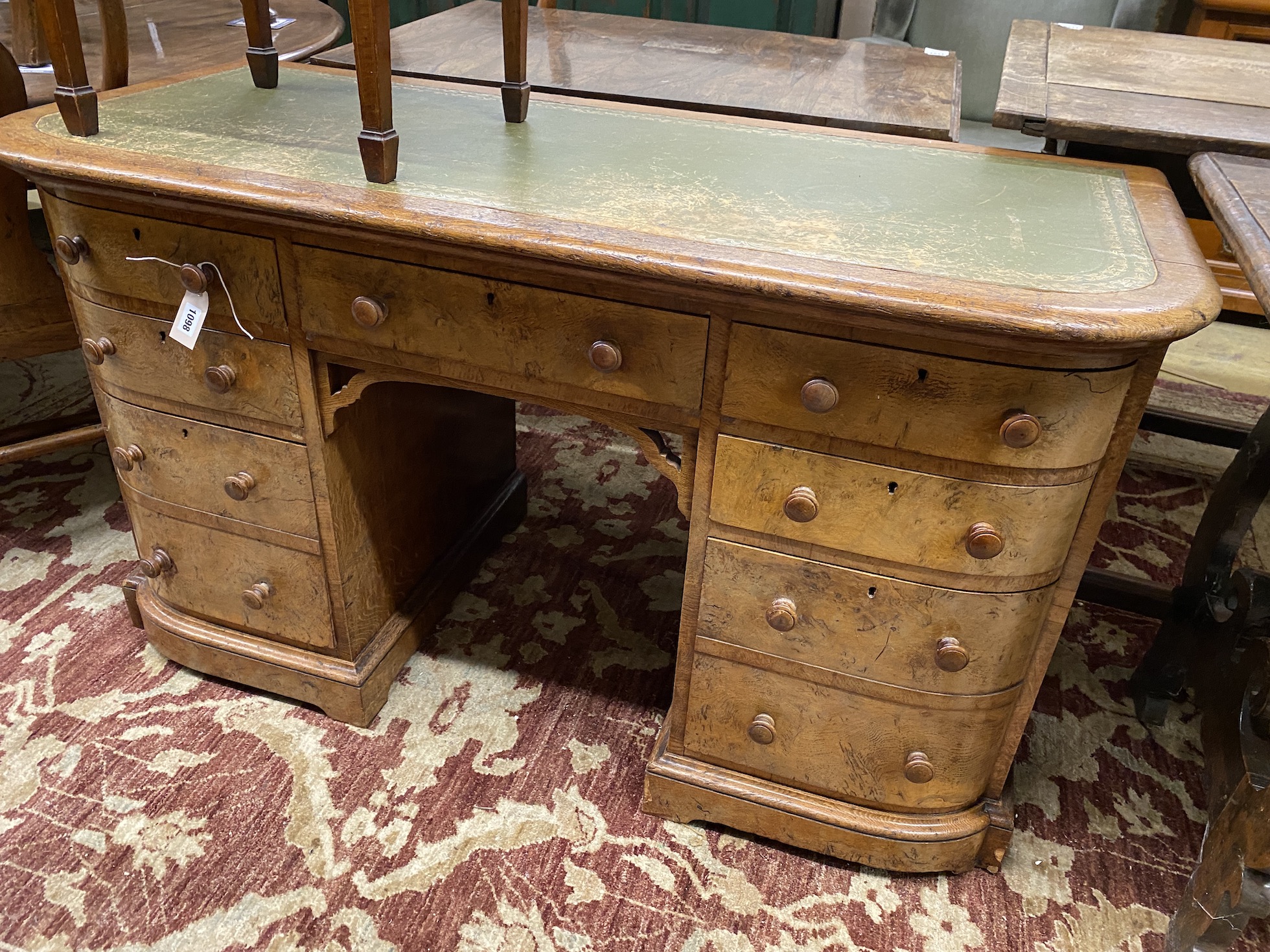 A Victorian oak bowfront kneehole desk, length 128cm, depth 55cm, height 72cm